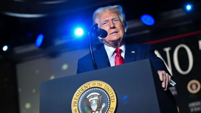 Trump stands at the podium as he delivers his speech