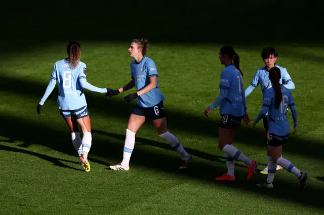 Miedema celebrates with teammates after scoring the equaliser