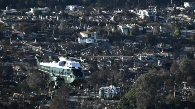 Marine One, carrying U.S. President Donald Trump, flies above devastation caused by wildfires around Los Angeles, California, U.S., January 24, 2