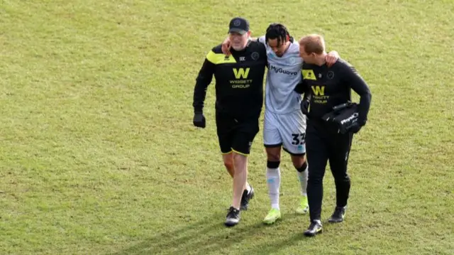 Calum Scanlon of Millwall leaves the field after suffering an injury