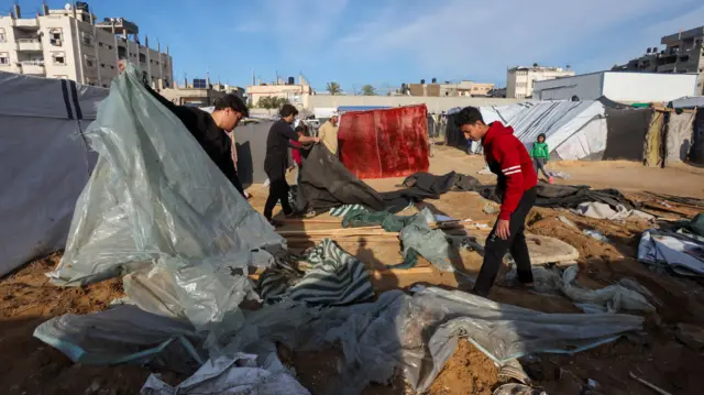 Palestinians, displaced by Israel's order into southern Gaza during the war, dismantle their tent as they wait to be allowed to return to their home in northern Gaza, amid a ceasefire between Israel and Hamas, in Deir Al-Balah in the central Gaza Strip