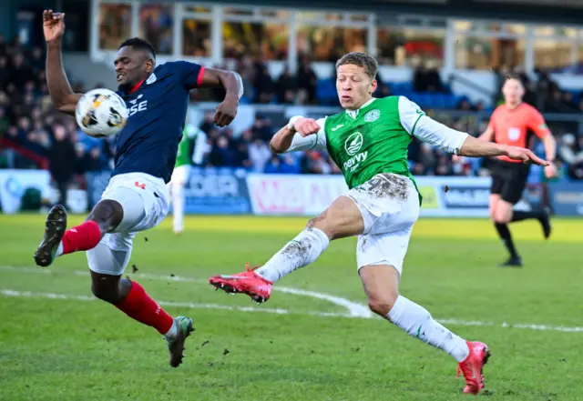 Hibernian's Dwight Gayle (R) and Ross County's Akil Wright in action during a William Hill Premiership match between Ross County and Hibernian at the Global Energy Stadium,