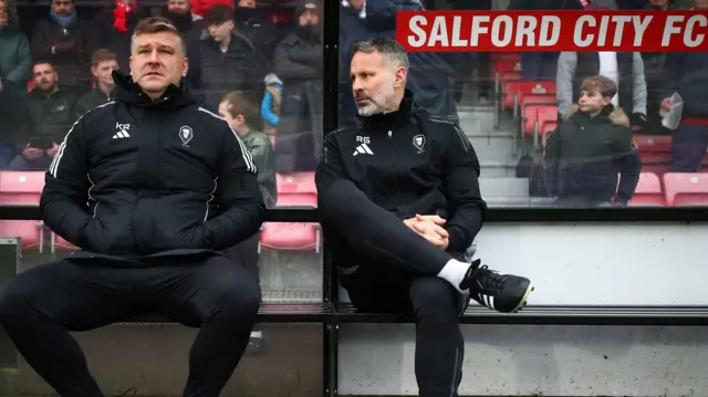 Salford City's Karl Robinson and Ryan Giggs sit next to each other.