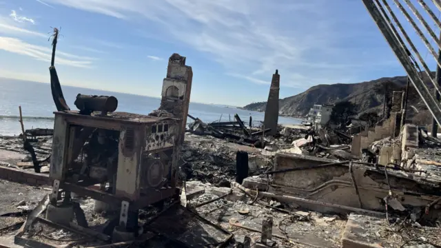 Burnt out house with ocean in background