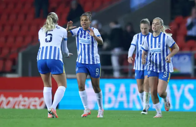 Parris celebrates with teammates after scoring v Liverpool