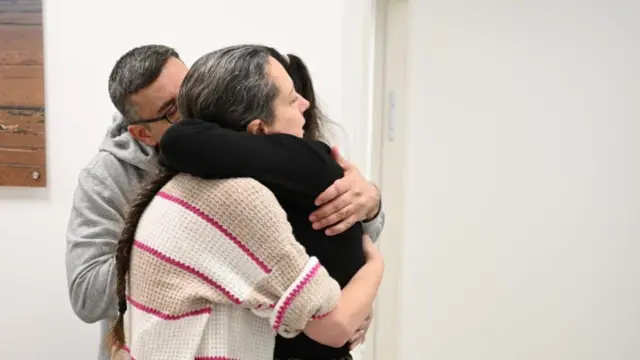 Karina Ariev hugs her parents