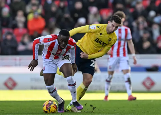 Stoke City's Junior Tchamadeu and Oxford United's Ruben Rodrigues battle for the ball