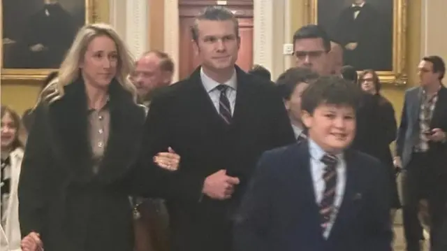 Man and woman walk arm in arm as young boy walks in front of them