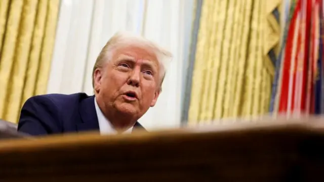 U.S. President Donald Trump sits in the Oval Office of the White House