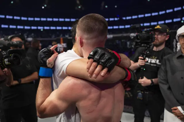 Paul Hughes hugs Usman Nurmagomedov