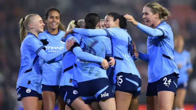 Lily Murphy of Manchester City celebrates scoring her team's second goal with teammates.