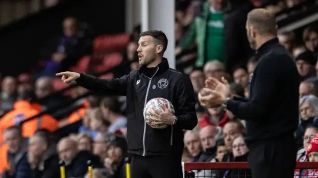 Walsall boss Mat Sadler directing his team from the dugout