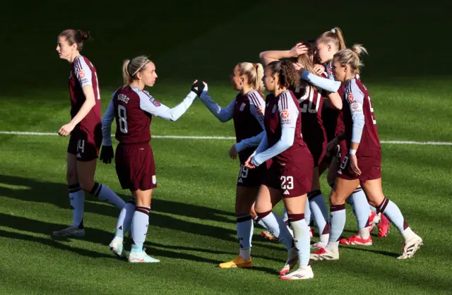 Villa players celebrate their equaliser via an own goal