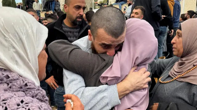 A freed Palestinian prisoner is greeted after being released from an Israeli jail as part of a hostages-prisoners swap and a ceasefire deal in Gaza between Hamas and Israel, in Ramalla