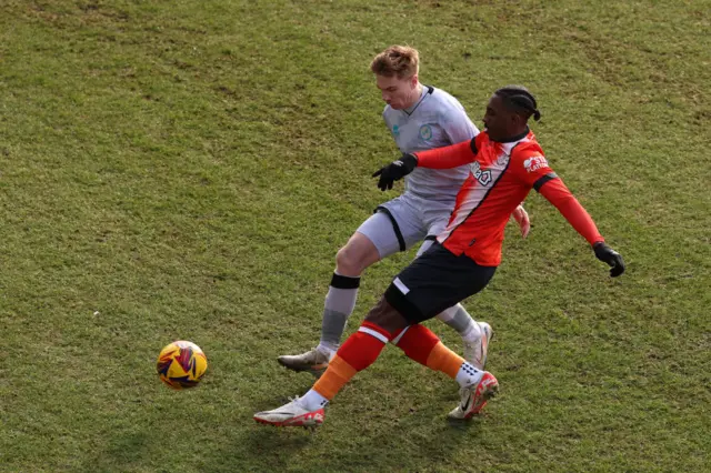 Duncan Watmore of Millwall is challenged by Amari'i Bell of Luton Town