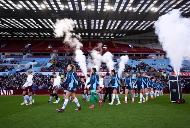 The players walk onto the pitch at Villa Park