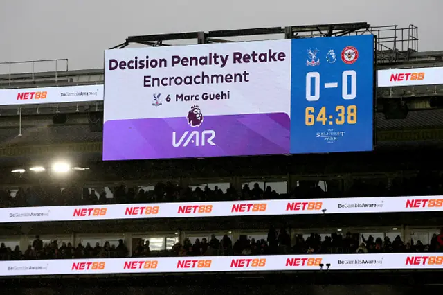 The LED board shows the VAR decision of a penalty retake