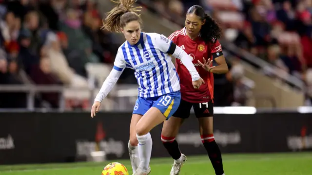 Marisa Olislagers of Brighton & Hove Albion is put under pressure by Jayde Riviere of Manchester United during the Barclays Women's Super League match between Manchester United and Brighton & Hove Albion