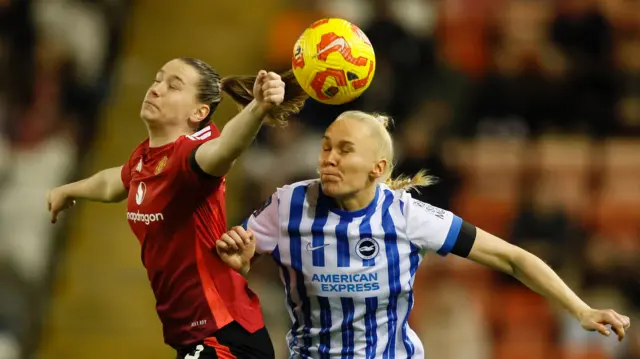 Manchester United women's Elisabeth Terland (left) and Brighton and Hove Albion Women's Maria Thorisdottir (right) challenge during the Barclays Women's Super League match at Leigh Sports Village.