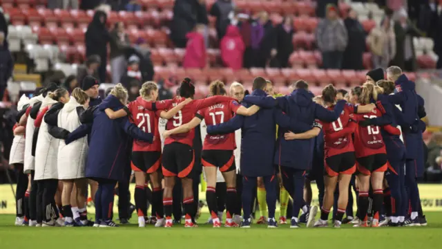 Players and staff of Manchester United huddle after the Barclays Women's Super League match between Manchester United and Brighton & Hove Albion at Leigh Sports Village