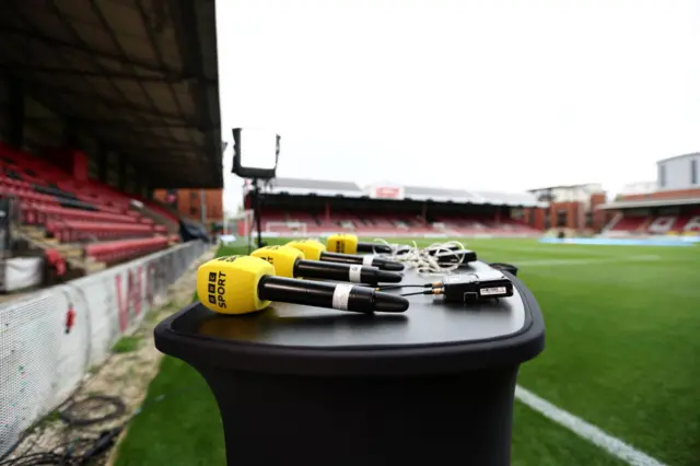 BBC microphones on a presentation table at Brisbane Road