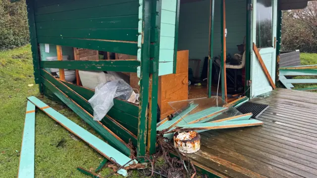 Wooden boards ripped off a summer cabin