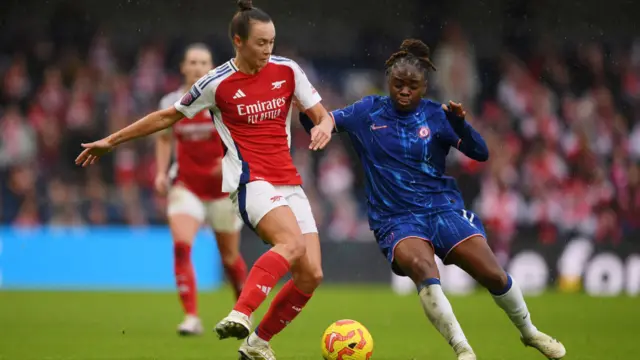 Caitlin Foord of Arsenal is challenged by Sandy Baltimore of Chelsea during the Barclays Women's Super League match between Chelsea FC and Arsenal FC at Stamford Bridge