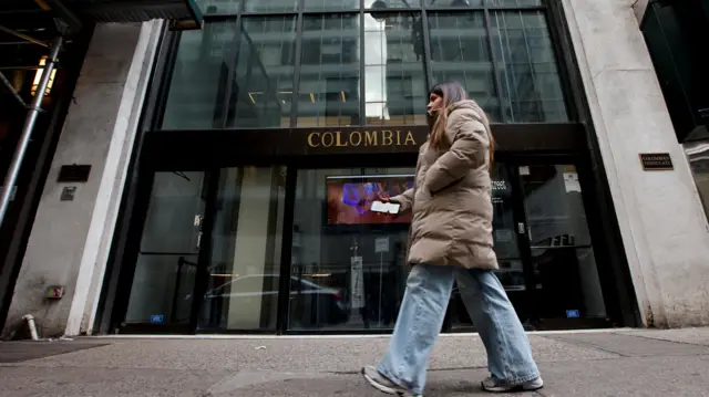 A woman walks in front of Colombia's consulate, after U.S. President Donald Trump said he would impose retaliatory measures after the South American country turned away two U.S. military aircraft with migrants being deported, in New York City, U.S