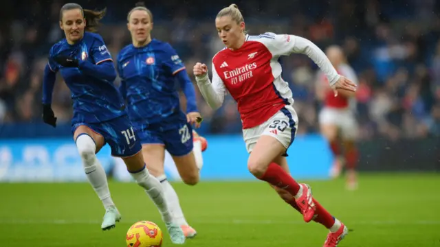 Alessia Russo of Arsenal runs with the ball whilst under pressure from Nathalie Bjorn of Chelsea during the Barclays Women's Super League match between Chelsea FC and Arsenal FC at Stamford Bridge