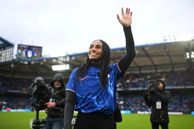 Naomi Girma waves to the crowd at Stamford Bridge