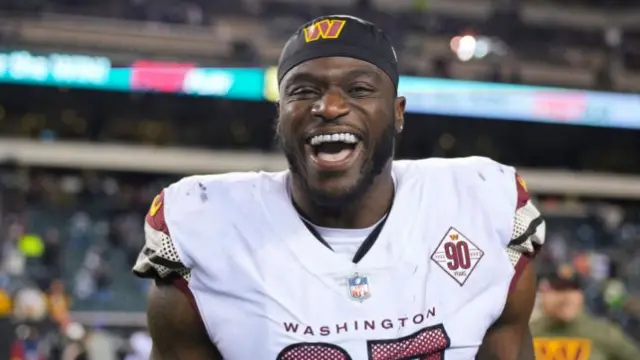 Efe Obada smiles after a game with the Washington Commanders