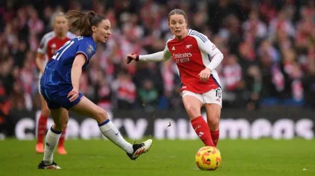 Kim Little of Arsenal passes the ball whilst under pressure from Niamh Charles of Chelsea during the Barclays Women's Super League match between Chelsea FC and Arsenal FC at Stamford Bridge