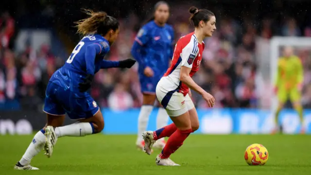 Emily Fox of Arsenal runs with the ball whilst under pressure from Catarina Macario of Chelsea during the Barclays Women's Super League match between Chelsea FC and Arsenal FC