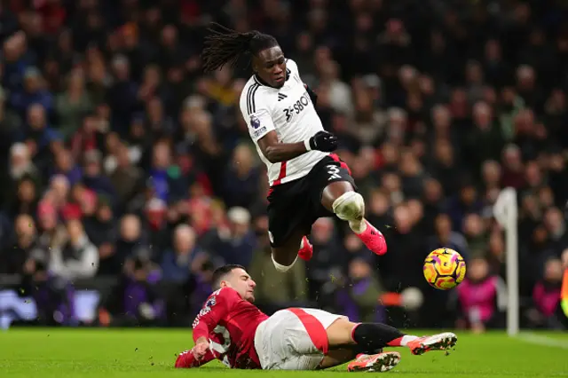 Diogo Dalot of Manchester Utd tackles Calvin Bassey of Fulham