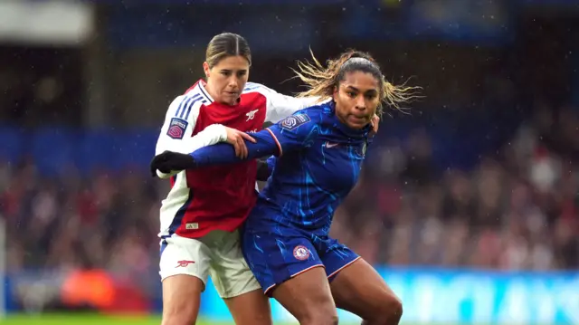 Arsenal's Kyra Cooney-Cross (left) and Chelsea's Catarina Macario battle for the ball during the Barclays Women's Super League match at Stamford Bridge