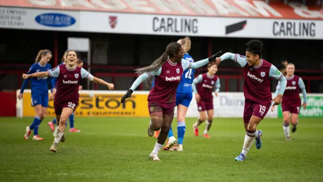 Viviane Asseyi of West Ham United celebrates with teammates after scoring to make it 1-0 during the Barclays Women's Super League match between West Ham United and Everton FC at Chigwell Construction Stadium