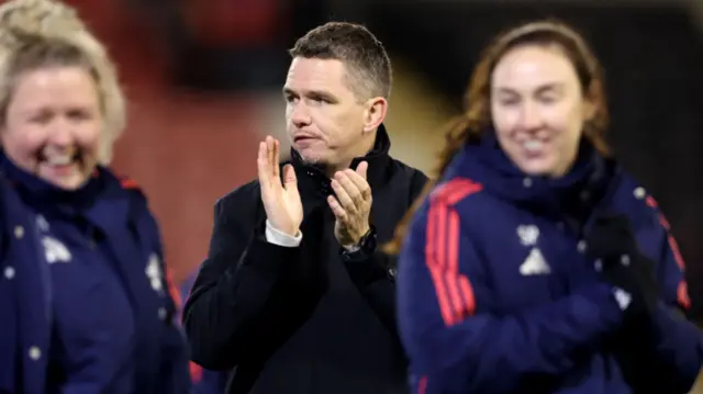 Marc Skinner, Manager of Manchester United, acknowledges the fans after the Barclays Women's Super League match between Manchester United and Brighton & Hove Albion at Leigh Sports Village