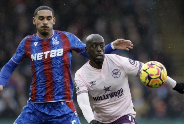 Crystal Palace's Maxence Lacroix (left) and Brentford's Yoane Wissa (right) battle for the ball