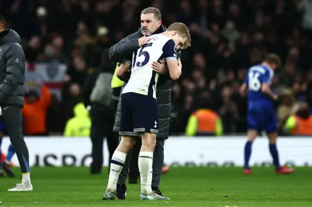 Tottenham Hotspur's Greek-Australian Head Coach Ange Postecoglou (C) consoles Tottenham Hotspur's Swedish midfielder #15 Lucas Bergvall