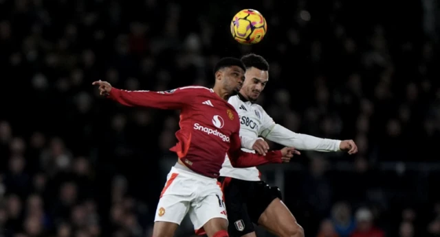 Manchester United's Amad Diallo (left) and Fulham's Antonee Robinson (right) battle for the ball