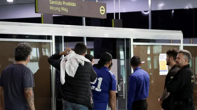 Migrants boarding a plane