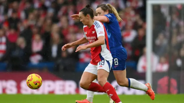 Caitlin Foord of Arsenal is challenged by Erin Cuthbert of Chelsea during the Barclays Women's Super League match between Chelsea FC and Arsenal FC at Stamford Bridge