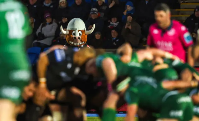 Glasgow mascot looks on as Warriors and Connacht contest a scrum