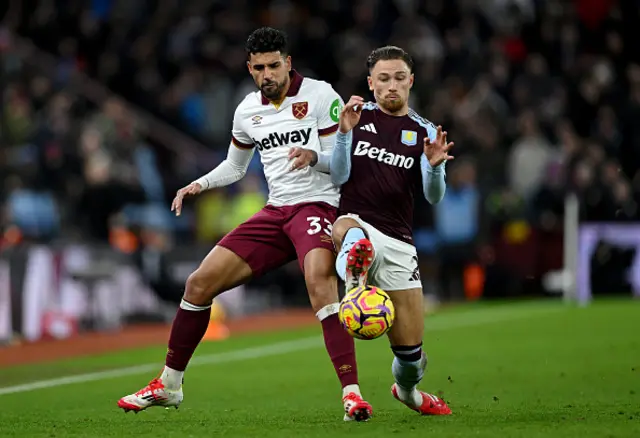 Emerson Palmieri of West Ham United is challenged by Matty Cash