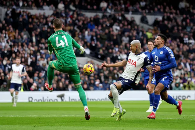 Richarlison of Tottenham Hotspur shoots under pressure from James Justin