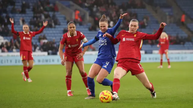 Jenna Clark of Liverpool is challenged by CJ Bott of Leicester City during the Barclays Women's Super League match between Leicester City and Liverpool FC