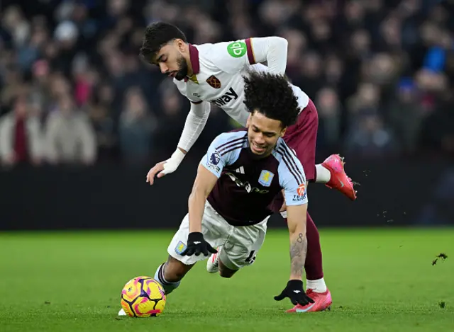 Boubacar Kamara of Aston Villa is challenged by Lucas Paqueta