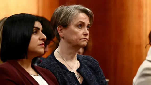 Britain's Justice Secretary Shabana Mahmood and Britain's Home Secretary Yvette Cooper listen as Prime Minister Keir Starmer (unseen) speaks during a press conference.