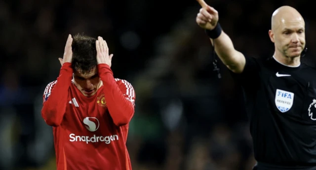 Manchester United's Manuel Ugarte and referee Anthony Taylor react