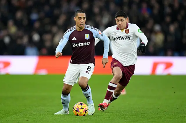 Youri Tielemans of Aston Villa runs with the ball under pressure